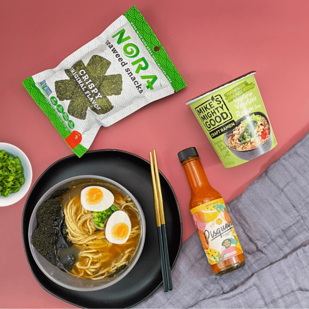 Hot bowl of ramen served with nori seaweed and hot sauce