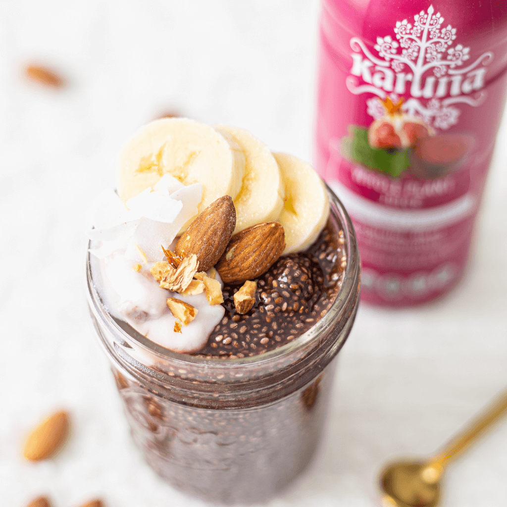 delicious smoothie in a jar topped with bananas and almonds