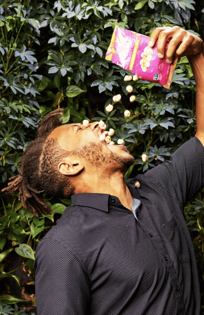 Man Snacking on a bag of snacks