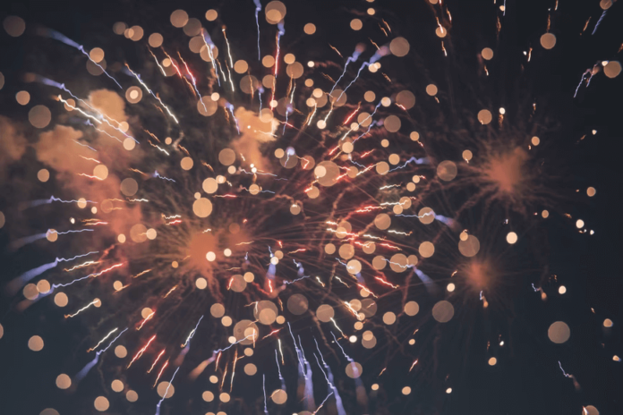 A firework exploding with glimmering embers, expressing celebration.