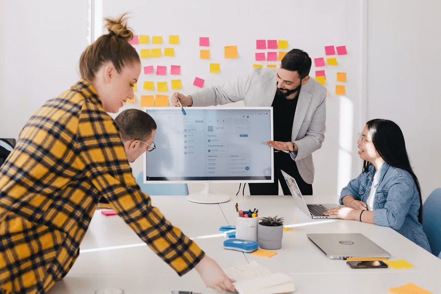 Coworkers gathering together in a conference room for a presentation.