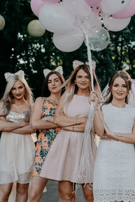 A bride and her wedding party posing for a photo.