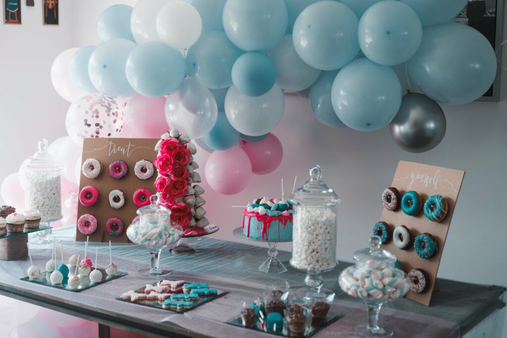 A spread of treats, cake, balloons and more to celebrate a birthday.